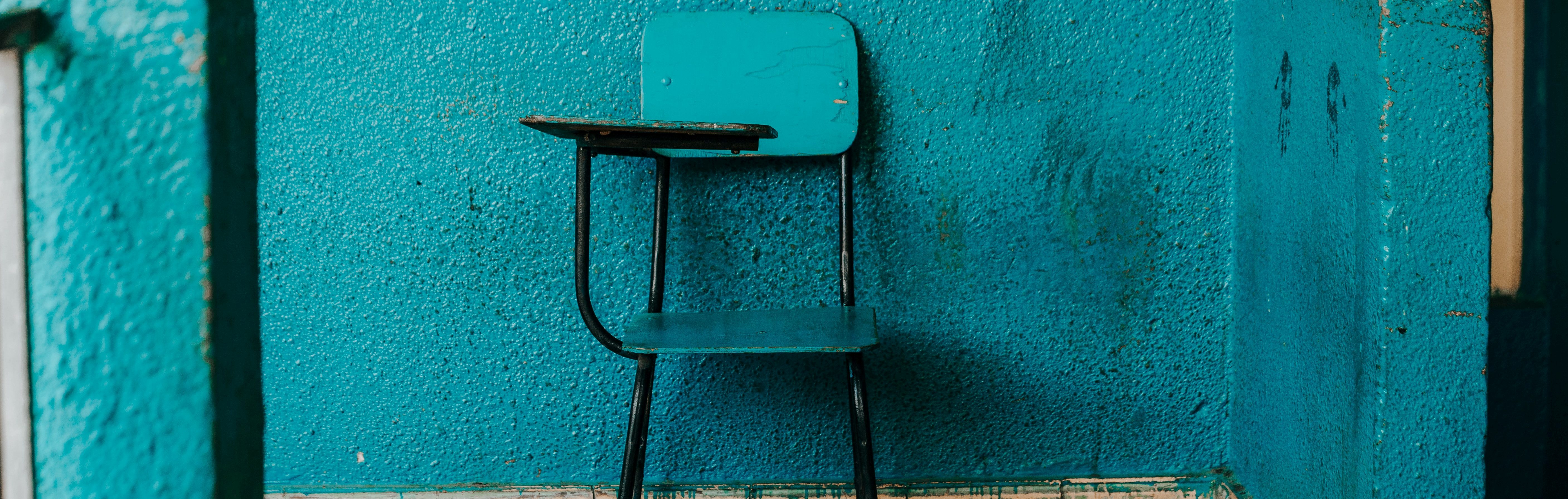 Photo of a small blue school desk