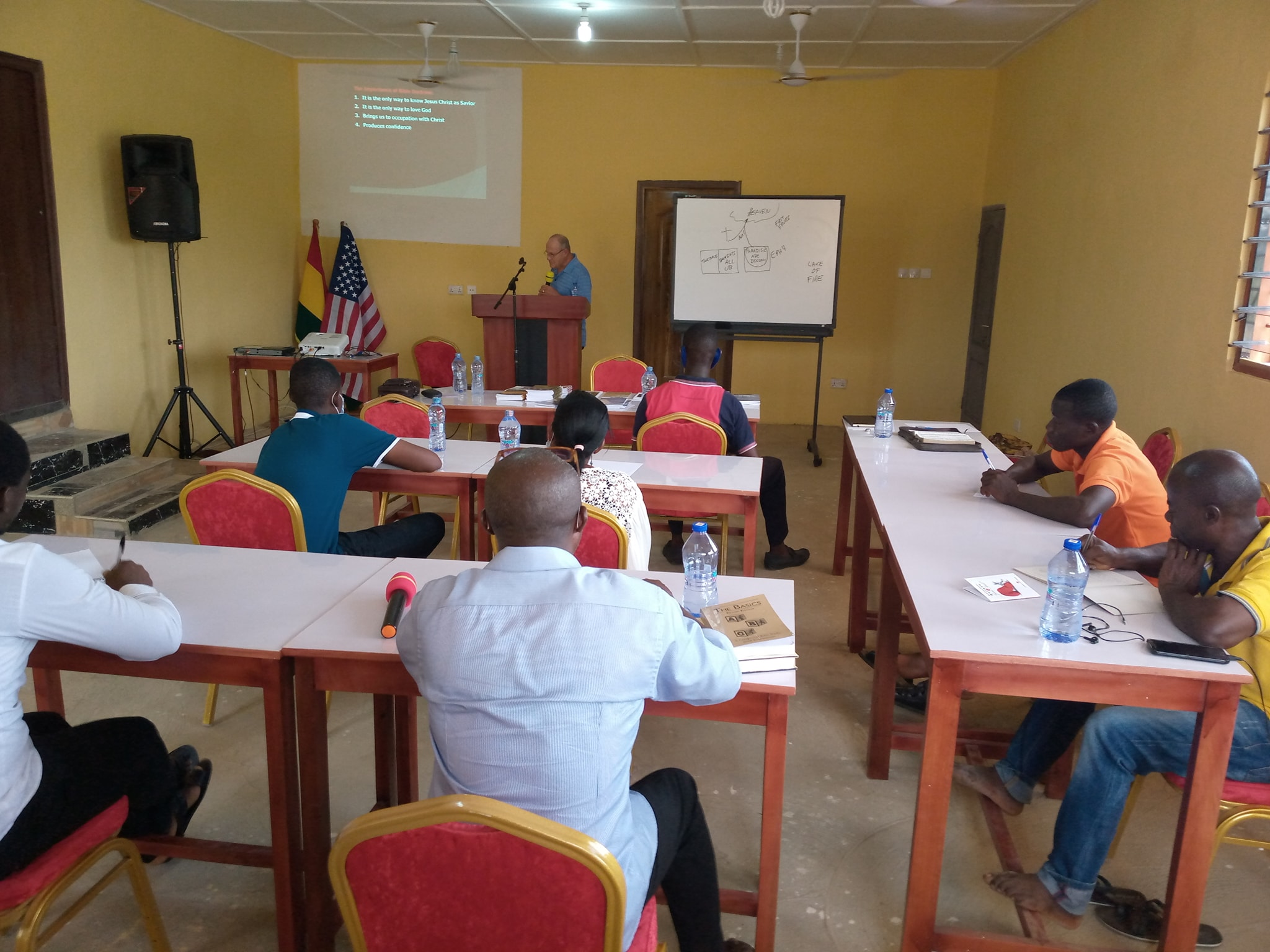 School full of students learning from a guest speaker