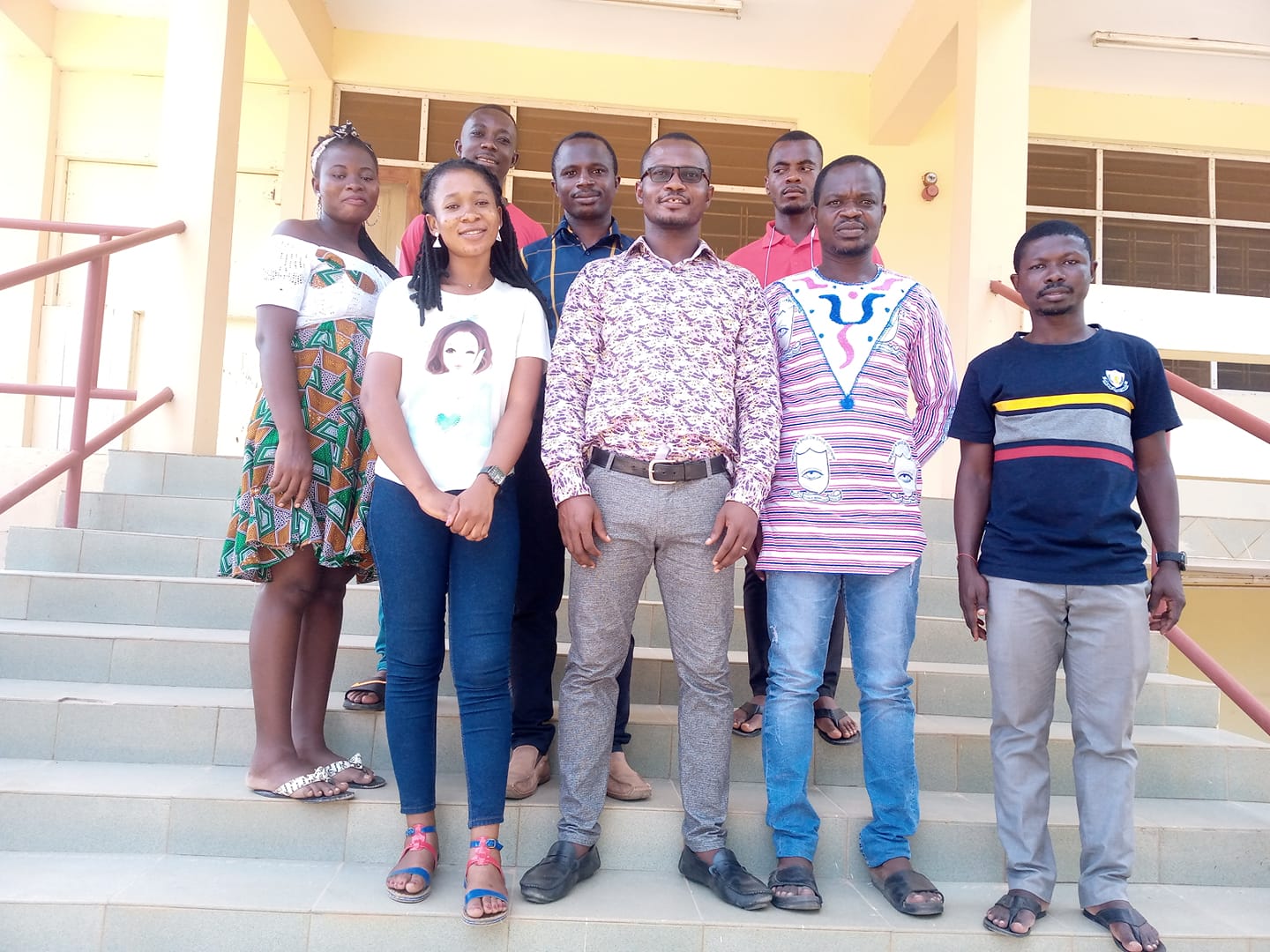 group of students standing on steps posing for photo